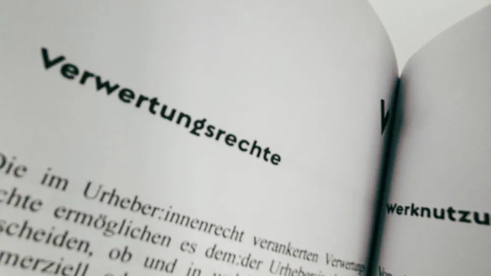 Offenes Buch mit Text über Verwertungsrechte.