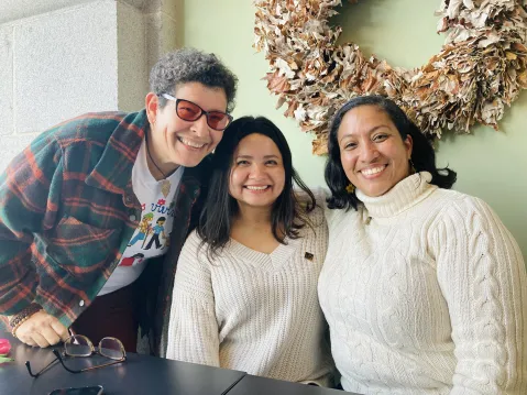 Three people posing for the photo