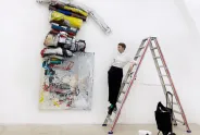The artist Olga Shcheblykina on the ledder in front of her art
