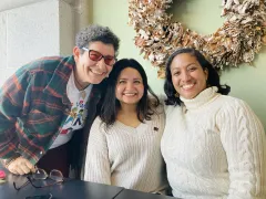 Three people posing for the photo