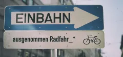 Einbahnstraße-Schild mit Fahrrad-Ausnahme.